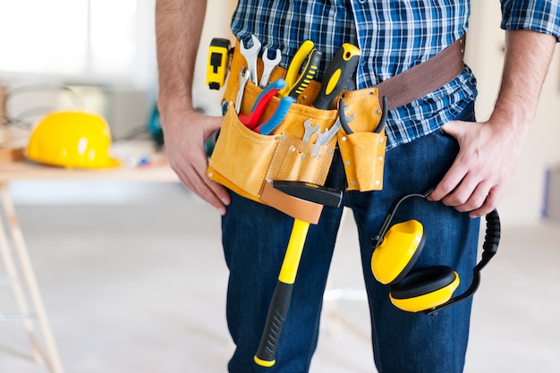 Part of construction worker with tools belt Free Photo