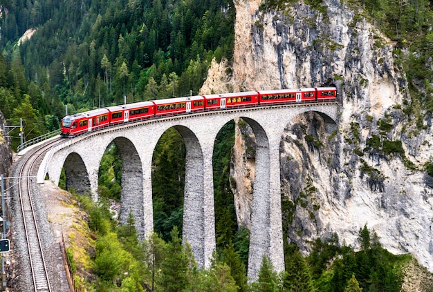 Premium Photo | Passenger train crossing the landwasser viaduct in the ...