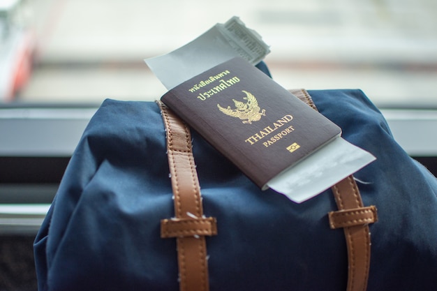 Passport on backpack at airport waiting traveling. Premium Photo