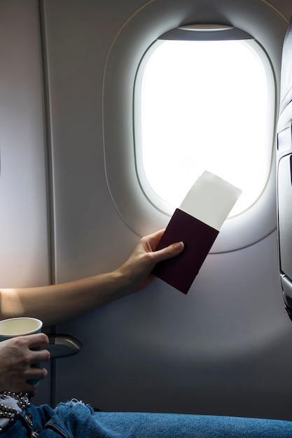 Passport and tickets next to a plane window | Free Photo