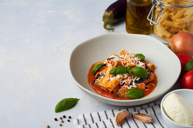 Premium Photo | Pasta alla norma with eggplant ricotta tomato sauce ...