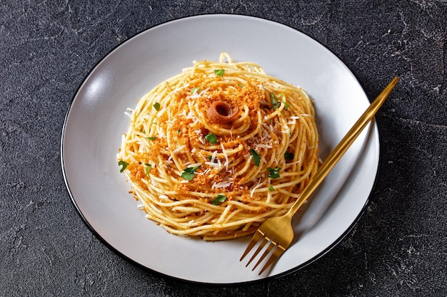 Premium Photo | Pasta mollicata: spaghetti with anchovies and toasted ...