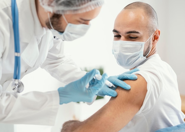 Patient being vaccinated in a clinic Free Photo