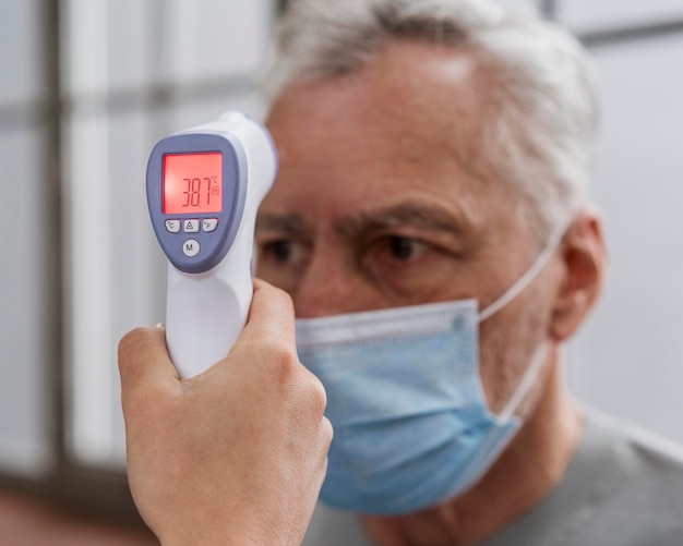 Free Photo | Patient having his temperature checked