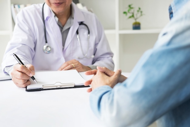 Premium Photo | Patient listening intently to a male doctor explaining ...