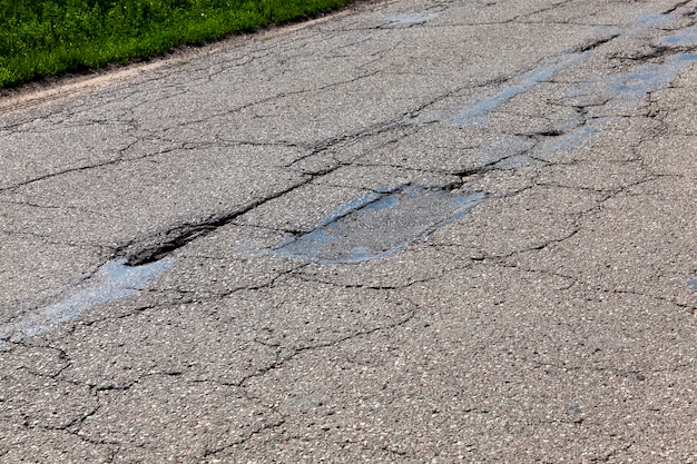 Premium Photo | Paved road with a lot of holes