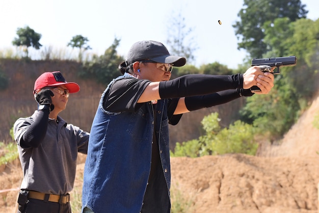 Pda Shooting Competition With Contestants Have A Timer And Score Standing Behind The Contestants Premium Photo