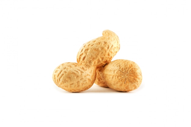 Peanuts. two peeled nuts isolated on white background. peanut macro. Premium Photo