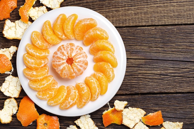 Premium Photo | Peeled tangerine and rind on old wooden table