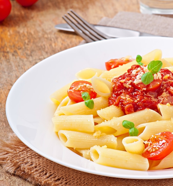 Free Photo | Penne pasta with bolognese sauce, parmesan cheese and basil