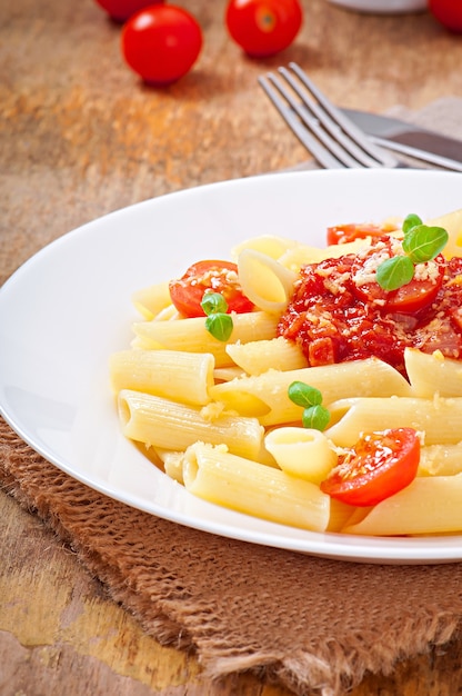 Free Photo | Penne pasta with bolognese sauce, parmesan cheese and basil