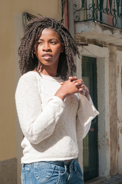 Free Photo Pensive pretty young black  woman  standing  