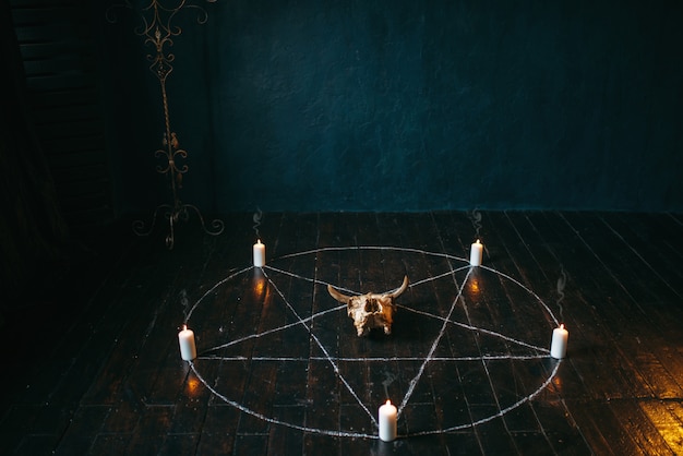 Premium Photo | Pentagram circle with candles on black wooden floor ...