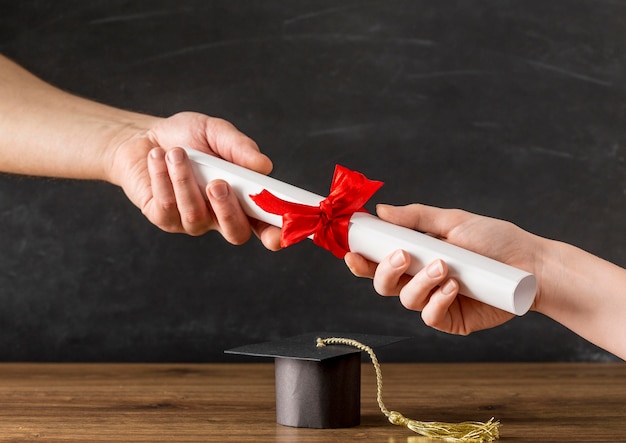 People handing a diploma to each other Free Photo