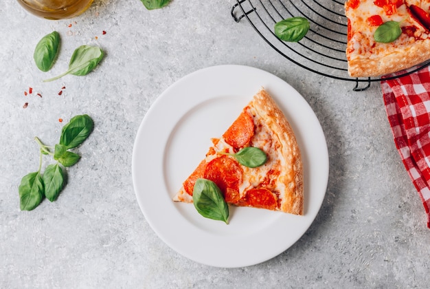 Pepperoni pizza slice on a plate Premium Photo