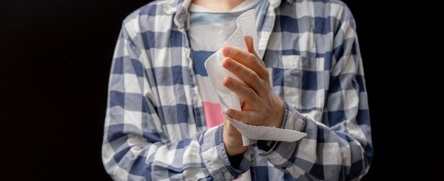 Person clean or wipe his hands with wet paper napkin Premium Photo