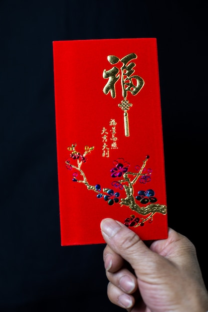 Free Photo | Person holding a chinese traditional red envelop for the ...