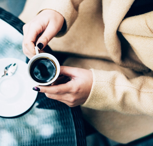 Free Photo | A person holding a cup of coffee