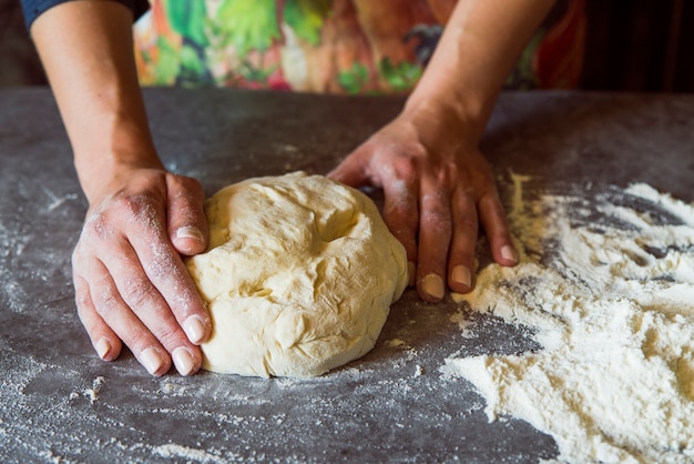 Free Photo | Person kneading the dough on table