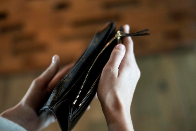 Premium Photo | A person opens the empty wallet to take some money ...