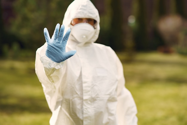 Person in a protective suit in a park Free Photo