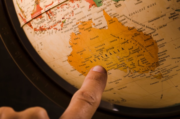 person s finger pointing australia country globe 23 2147837092