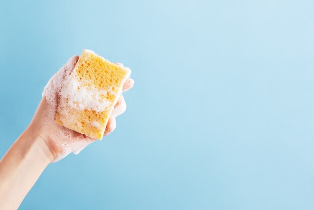 Premium Photo Persons Hand Holding Yellow Sponge For Dish Wash