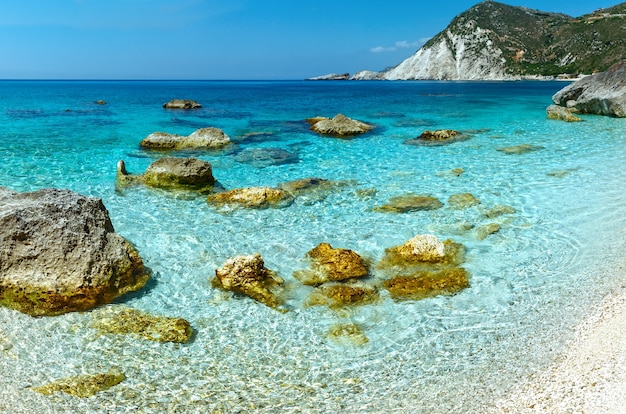 Premium Photo | Petani beach summer view with big stones in water ...