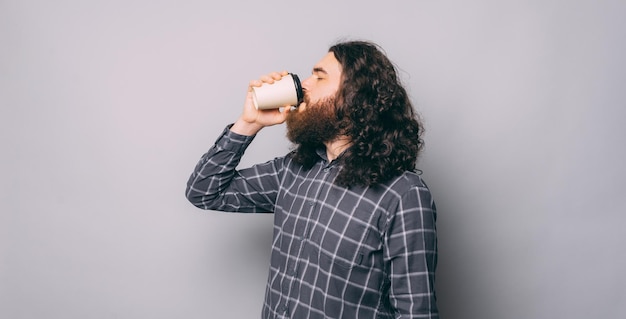 Premium Photo Photo Of Bearded Man In A Casual Drinking A Morning Takeaway Coffee