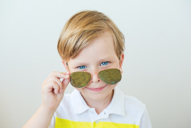 Premium Photo Photo Of A Beautiful Boy Looking Over Sunglasses