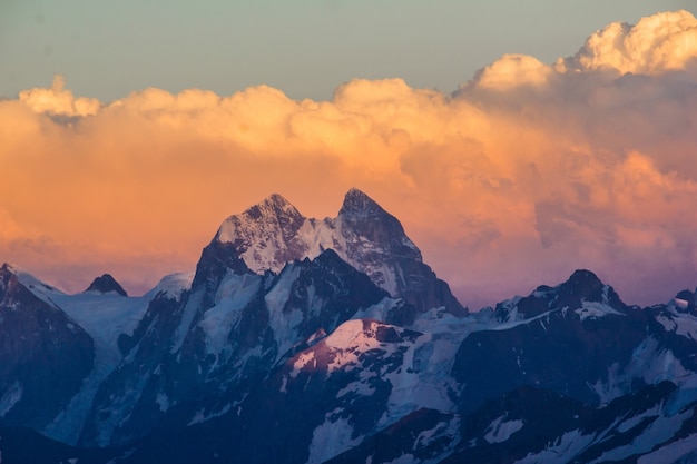 Premium Photo | Photo of beautiful mountains at sunset in the clouds