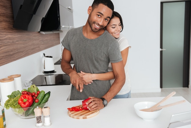 Premium Photo Photo Of Beautiful Young Couple In The Kitchen Hugging While Cooking 