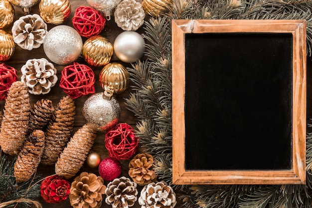 Photo frame near fir twigs and christmas toys Free Photo