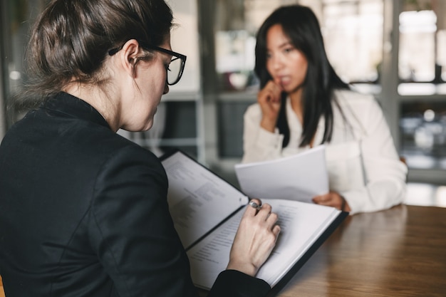 Premium Photo | Photo from back of serious businesswoman interviewing ...