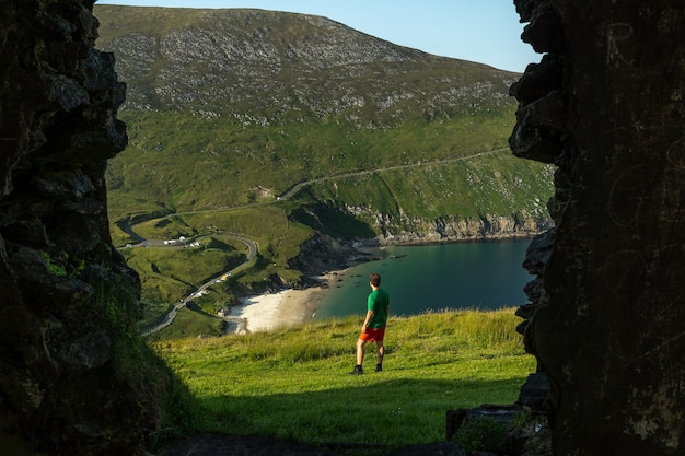 Premium Photo | Photo of man traveler in keem bay achill island ireland ...