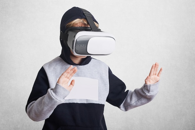 Photo Of Small Kid Wears Virtual Reality Goggles Free Photo