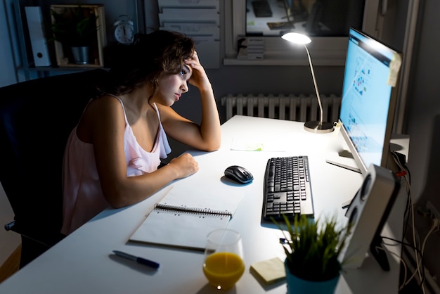 Photo of a tired woman working at home late at night. | Premium Photo