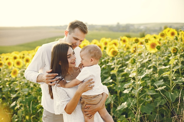 Free Photo | Photo of a young family at the sunflowers field on a sunny