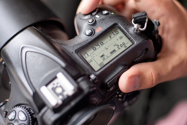 Premium Photo | Photographer setting up camera for a shooting