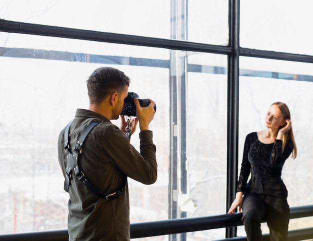Photographer taking pictures of young female model Free Photo