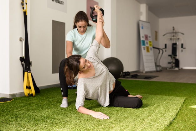 physiotherapist-assisting-young-caucasian-woman-with-exercise-with-dumbbell_1139-1246.jpg (626×417)