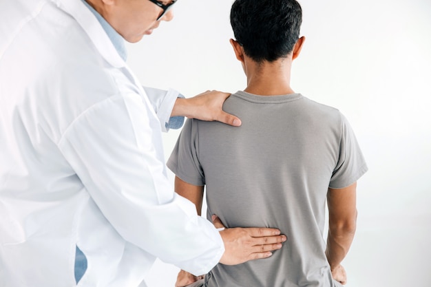 physiotherapist-doing-healing-treatment-man-s-back-back-pain-patient_38391-392.jpg (626×417)