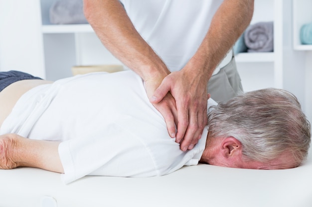 Premium Photo Physiotherapist Doing Shoulder Massage To His Patient