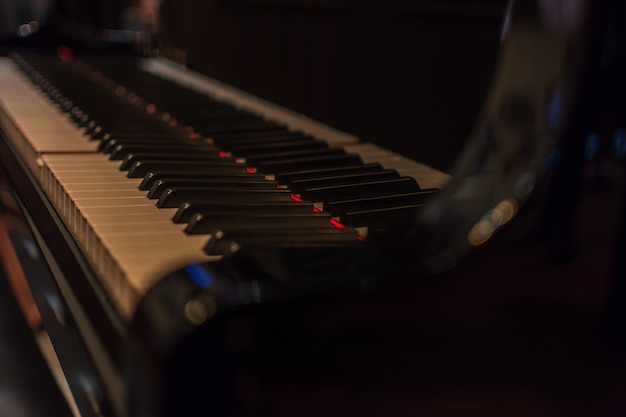 Premium Photo | Piano keys on black classical grand piano play a