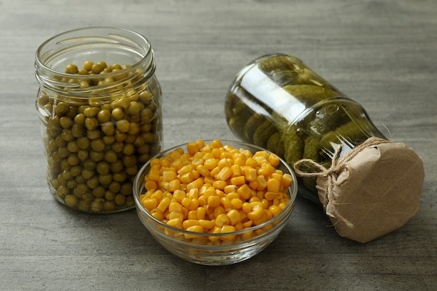  Pickled cucumbers, corn and peas on gray wall Premium Photo