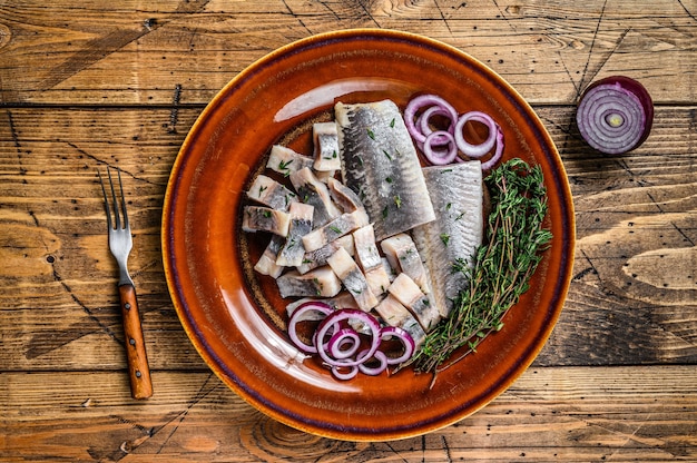 Premium Photo | Pickled marinated herring fish sliced fillet on a plate ...