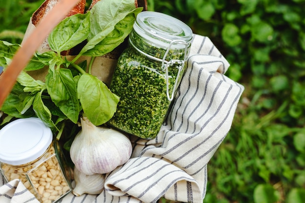 Download Premium Photo Picnic Basket With Traditional Italian Sauce Homemade Pesto In A Glass Jar Outdoors