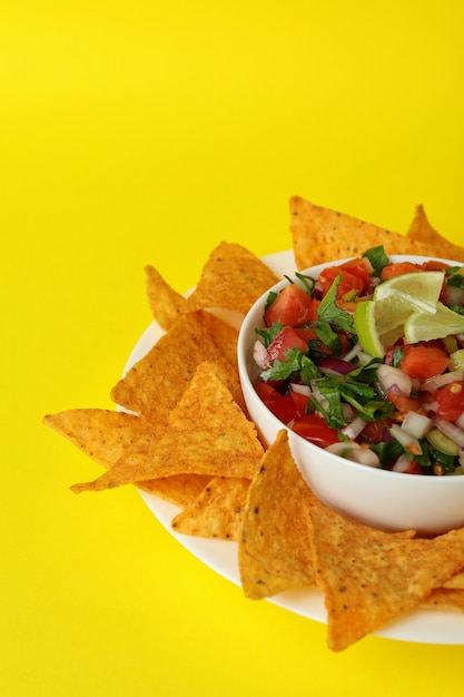 Premium Photo | Pico de gallo and chips on yellow background