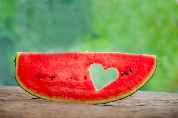 Premium Photo | Piece of watermelonwith heart at the backdrop of ...