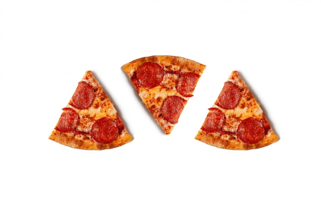 Pieces of pepperoni pizza isolated on white with shadow. Premium Photo